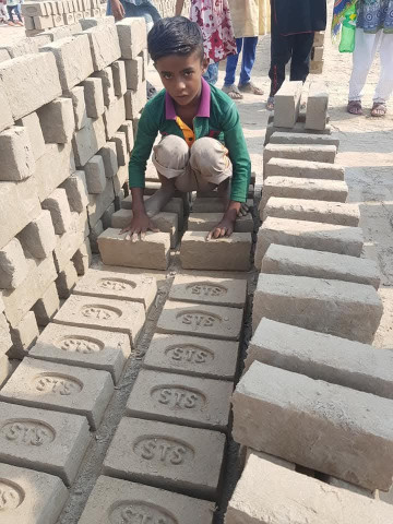 A child at a brick factory.